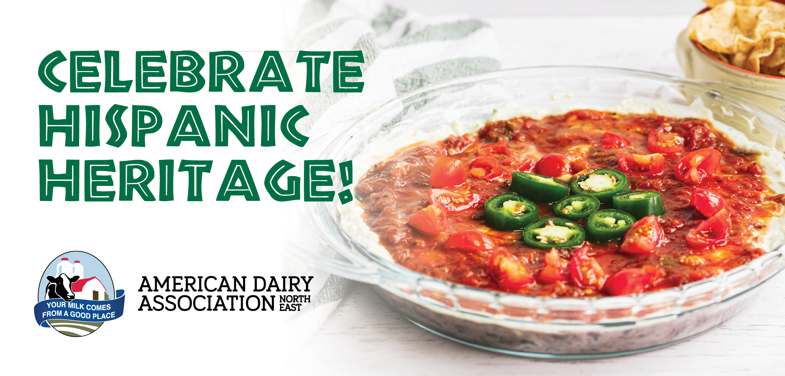 A taco dip in a glass bowl with the American Dairy Association logo and text reading, Celebrate Hispanic Heritage. A taco dip in a glass bowl with the American Dairy Association logo and text reading, Celebrate Hispanic Heritage.
